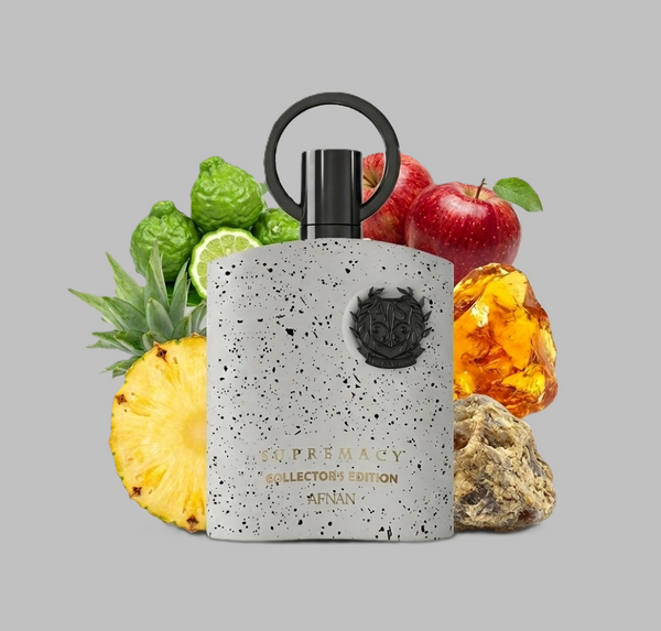 Afnan Supremacy Collectors Edition Perfume bottle with fruit elements on a gray background